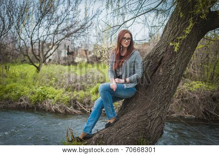Smiling young woman woman in glass near river