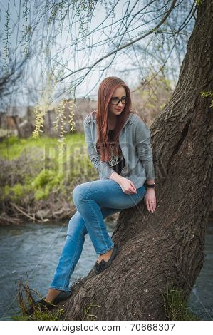 Smiling young woman woman in glass near river
