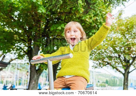Cute toddler boy playing on playground