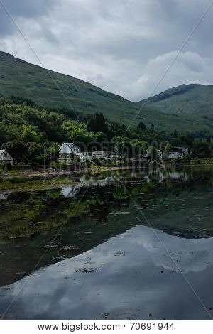Houses reflected in loch