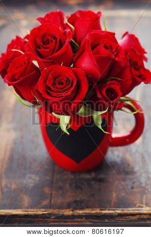 Valentine composition with roses on wooden background