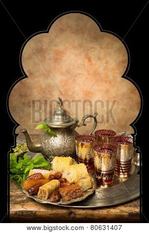Display of oriental cookies and iftar dates on a Moroccan tea tray