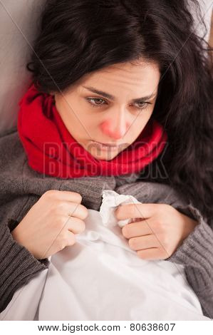 Young sick girl lying in bed