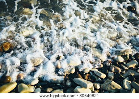 Wave of the ocean sea on the cobble beach