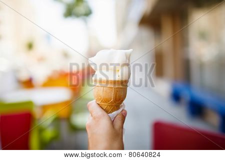 Ice cream in woman hand outdoors