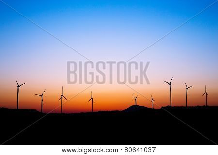 Wind farm silhouette in sunset light.