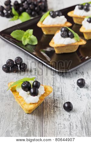 Canape With Cottage Cheese And  Black Berries Of Mountain Ash
