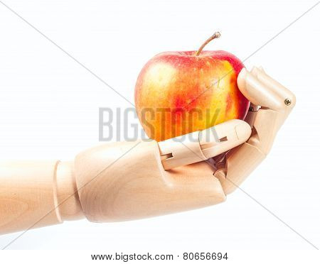 Wooden hand with apple isolated on a white background