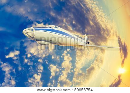 passenger plane flying in the sky at sunrise