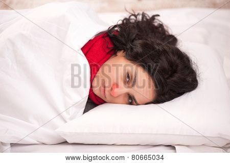 Frustrated sick girl in bed