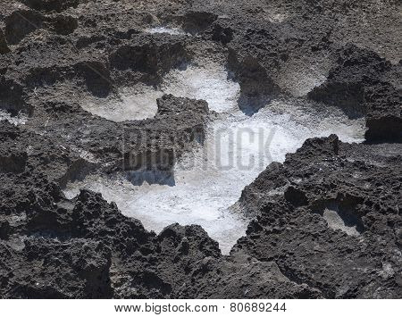 Salt Precipitation In Eroded Black Oxidized Limestone Cavities Near Mediterranean Sea.