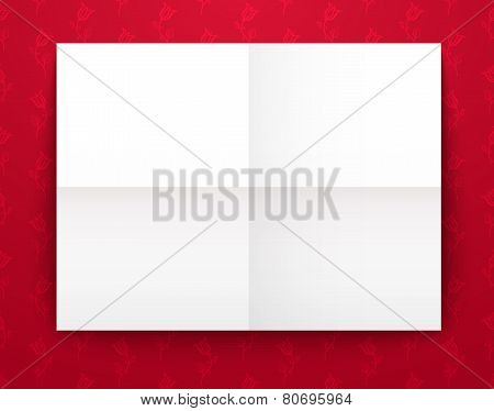 Empty old sheet of paper folded in fourfold on red background