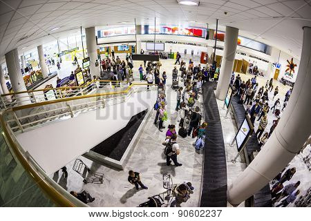 Tourists Wait For Their Baggage At The Airport