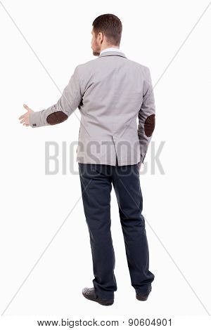 back view of businessman in jacket reaches out to shake hands. Rear view people collection. backside view of person.  A guy in a jacket with patches out his hand welcoming someone