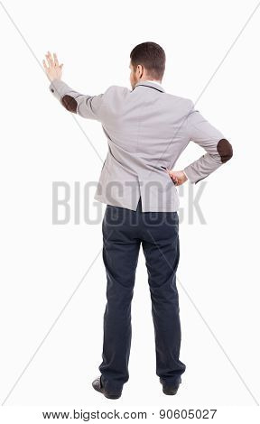 back view of business manr in jacket presses his hand. Young guy  gesture. Rear view people collection.  backside view of person.  Isolated over white background. 