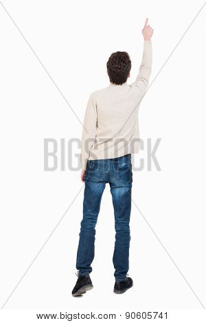 Back view of pointing business man. gesticulating young guy in black suit. Rear view people collection.  backside view of person.  The man saw something high up.