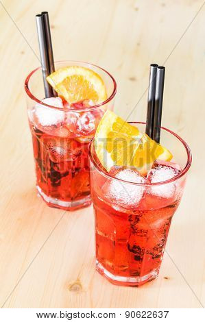 Two Glasses Of Spritz Aperitif Aperol Cocktail With Orange Slices And Ice Cubes On Wood Table
