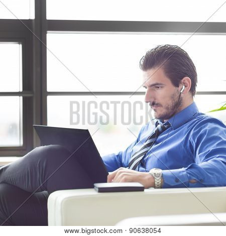 Businessman in office working on his laptop.