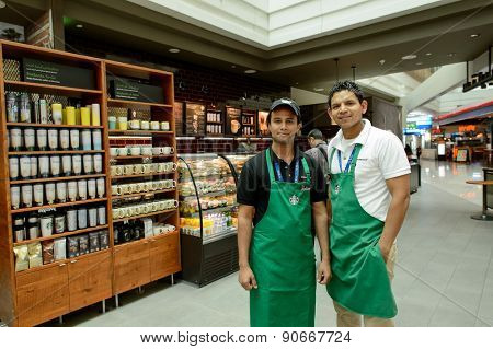 DUBAI, UAE - MARCH 10, 2015: Starbucks staff. Starbucks Corporation, doing business as Starbucks Coffee, is an American global coffee company and coffeehouse chain based in Seattle, Washington