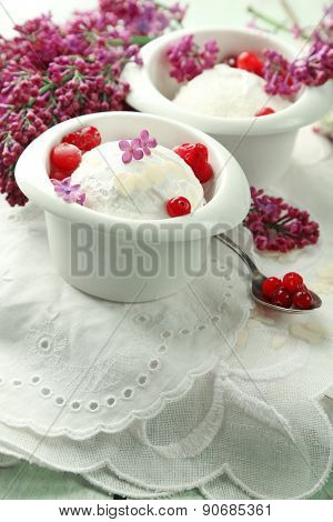 Beautiful composition with tasty ice cream and lilac flowers