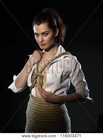 Shibari. Woman tied with rope in style of BDSM