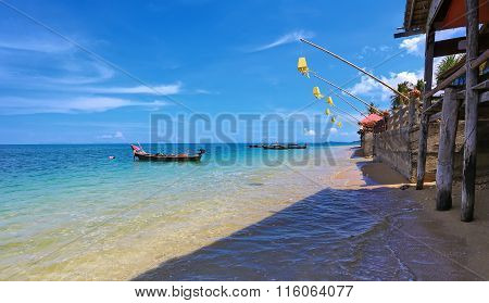 Cafe on the tropical beautiful beach with crystal clear water on the island of Koh Lanta (Thailand)