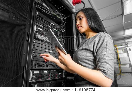 Engineer businesswoman in network server room