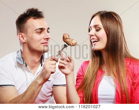 Smiling Man Feeding Happy Woman With Cake.