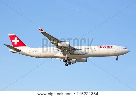 ZURICH - JULY 18: Swiss A-340 landing in Zurich airport on July 18, 2015 in Zurich, Switzerland. Zurich airport is home port for Swiss Air and one of the biggest european hubs.