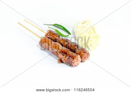 Thai Grilled Sausages On White Background Served With Cabbage And Chili Pepper. Thai Food