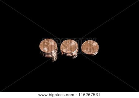 Three shrinking stacks of euro cent coins close-up