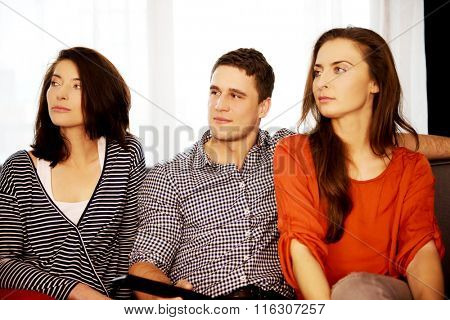 Sisters and brother relaxing at home.