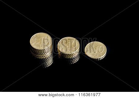 Three shrinking stacks of euro cent coins close-up