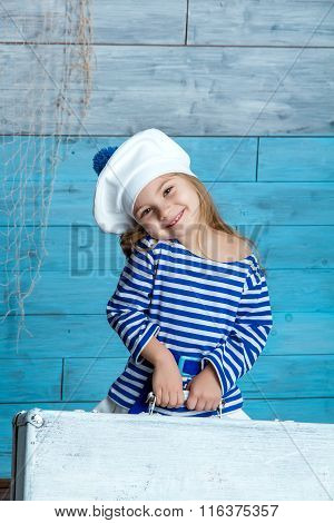girl in vest holding a suitcase