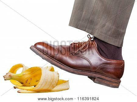 Leg In The Left Brown Shoe Slips On A Banana Peel