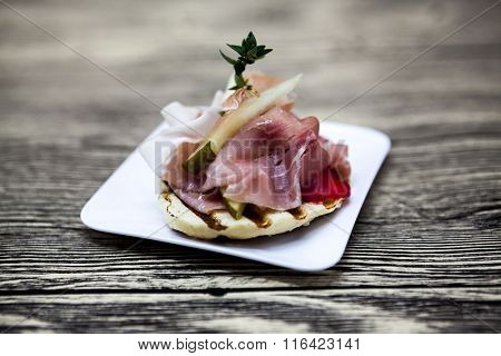 Fresh delicious Spanish tapas with hamon on the  wooden background . Great background for restaurant, cafe.