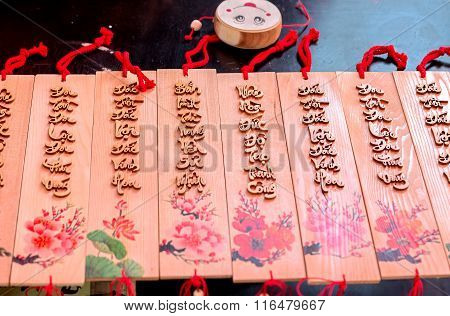 Painting New Year couplets written on wood