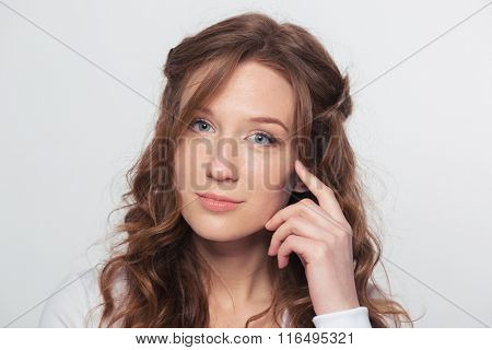 Beauty portrait of a young woman loooking at camera isolated on a white background
