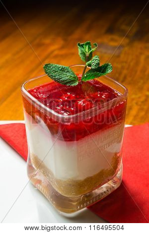 Cheesecake served in a glass, ready for consummation. Dessert.