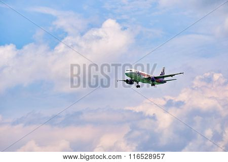 HONG KONG - JUNE 04, 2015: HK Express aircraft landing at Hong Kong airport. HK Express is a Hong Kong-based low-cost airline