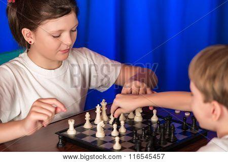 Children Play A Board Game Called Chess.