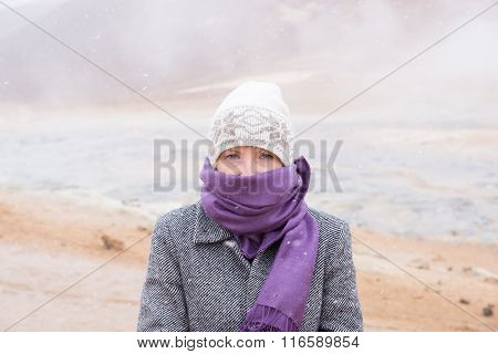 Woman standing in snow storm