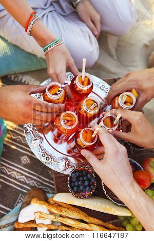 Group Of Friends Holding Drinks At The Summer Picnic