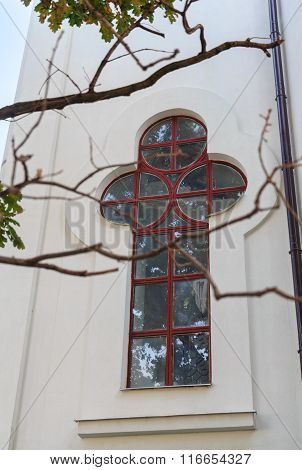 Church Window In The Shape Of A Cross. Religion