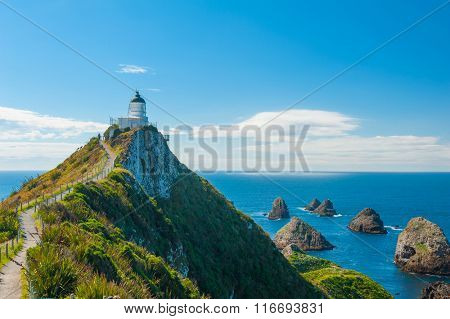 Lighthouse on Nugget Point. It is located in the Catlins area on the Southern Coast of New Zealand, Otago region. The Lighthouse is surrounded by small rock islands, nuggets