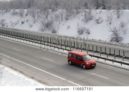 Bucharest Romania 23 January 2016: A red cars passes the high-speed A2 the main commercial route which connects Bucharest to the Black Sea's port Constantza.