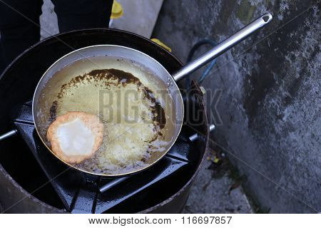 Fried Fritter Dipped In Boiling Oil In An Aluminum Pot