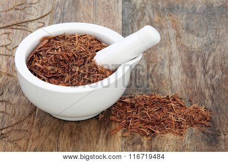 Catuaba bark herb used in natural alternative herbal medicine in a mortar with pestle over old wood background. Used as an aphrodisiac to increase libido.
