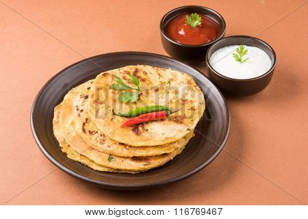 Traditional Indian bread - Aloo paratha or aalu parotha, potato stuffed bread. served with tomato ke