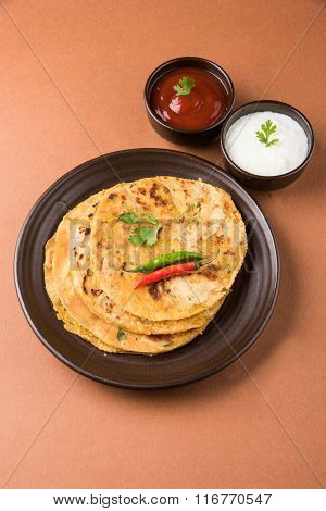 Traditional Indian bread - Aloo paratha or aalu parotha, potato stuffed bread. served with tomato ke